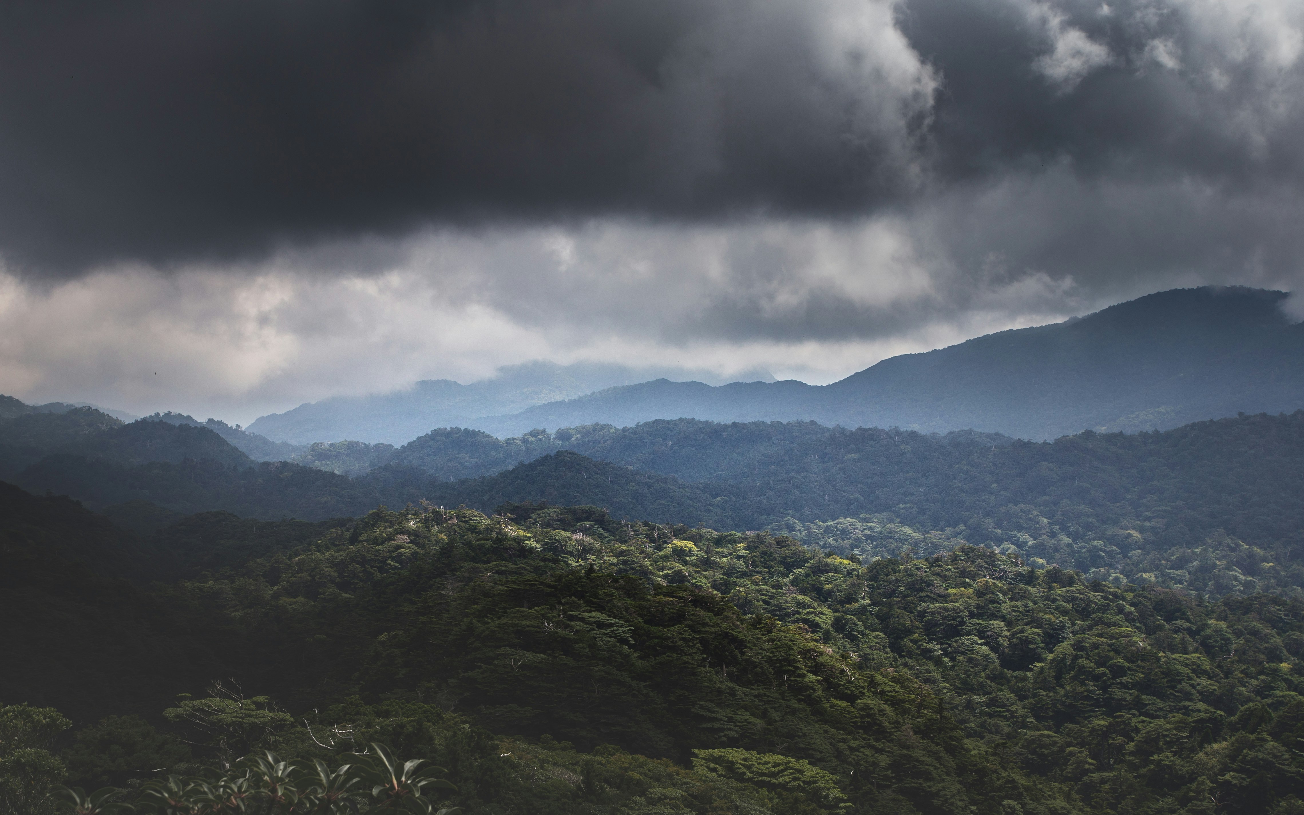 green mountains under white clouds during daytime